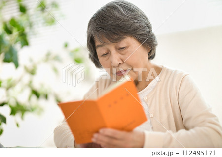 年金手帳を見ながらパソコンを使うシニア女性 終活 年金手帳を見ながらパソコンを使うシニア女性 終活 112495171