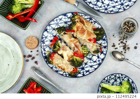 Meat rolls with broccoli and pepper on a plate. Meat rolls with broccoli and pepper on a plate. 112495224