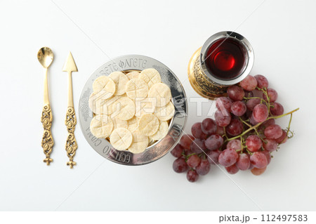 Bread on plate, cup, grapes and cutlery on white background, top view Bread on plate, cup, grapes and cutlery on white background, top view 112497583