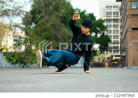 Talented Asian male dancer practicing hip hop dance on the street 112497968