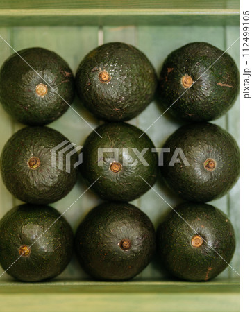 A Bunch Of Avocados Are Stacked On Top Of Each Other On A Green Surface 112499106