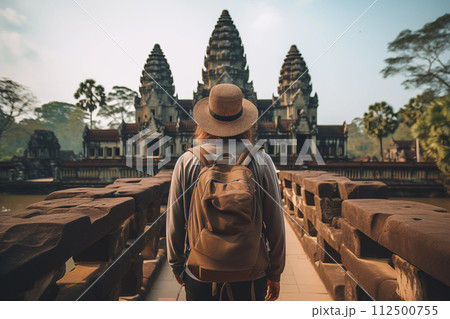 Unrecognizable male traveler wearing a hat exploring the ancient ruins in Asia Unrecognizable male traveler wearing a hat exploring the ancient ruins in Asia 112500755