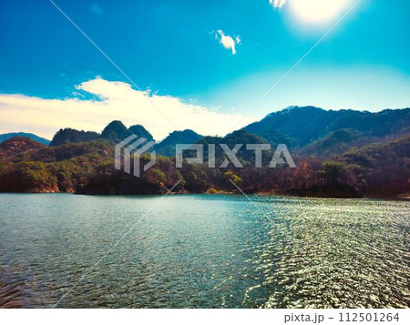 Blue water lake and beautiful mountain scenery Blue water lake and beautiful mountain scenery 112501264