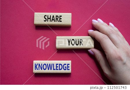 Share your knowledge symbol. Concept word Share your knowledge on wooden blocks. Businessman hand. Beautiful red background. Business and Share your knowledge concept. Copy space 112501743