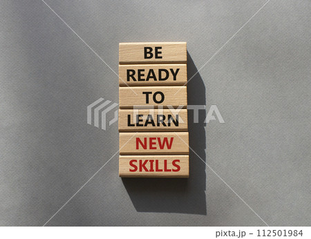 Learn new skills symbol. Concept words Be ready to Learn new skills on wooden blocks. Beautiful grey background. Business and Learn new skills concept. Copy space. 112501984