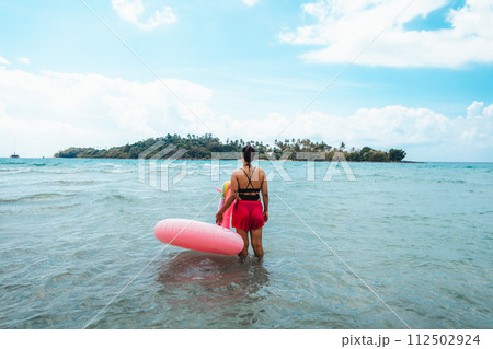 Travel to the sea and islands Woman walking into the clear sea on the island 112502924
