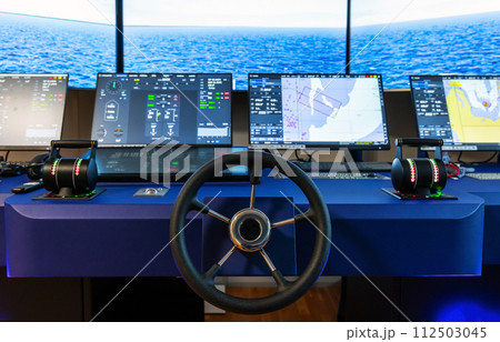 Modern ship control panel with steering wheel and engine accelerators 112503045