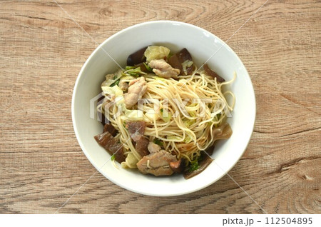 fried Chinese yellow rice noodles with cabbage and pork on bowl fried Chinese yellow rice noodles with cabbage and pork on bowl 112504895