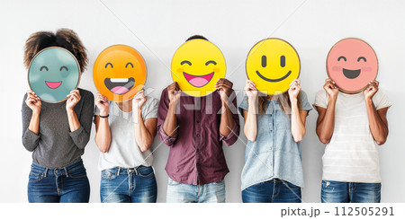 Healthy workplace culture concept. A group of diverse people holding happy emoticons. Teamwork 112505291