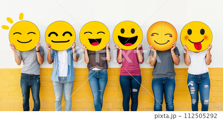 Healthy workplace culture concept. A group of diverse people holding happy emoticons. Teamwork 112505292
