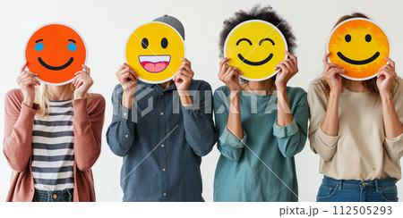 Healthy workplace culture concept. A group of diverse people holding happy emoticons. Teamwork 112505293