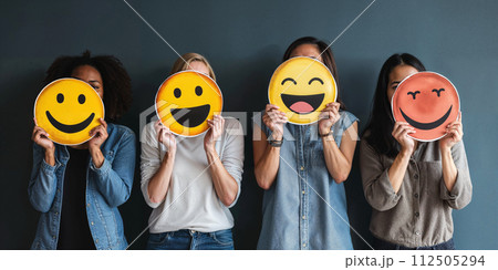 Healthy workplace culture concept. A group of diverse people holding happy emoticons. Teamwork 112505294