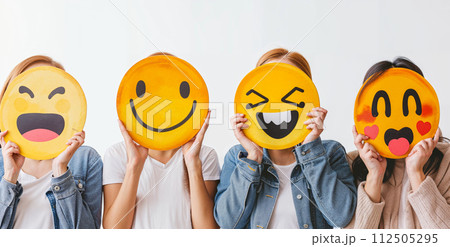 Healthy workplace culture concept. A group of diverse people holding happy emoticons. Teamwork 112505295