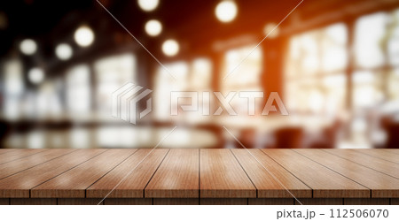 Empty wooden table top with lights bokeh on blur restaurant background. Empty wooden table top with lights bokeh on blur restaurant background. 112506070