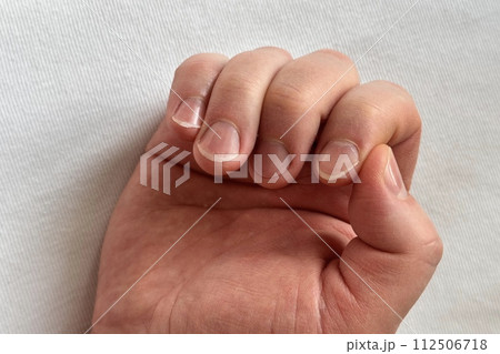A man's hand with long uncut damaged nails. Unkempt nails of a man on a white background. Close-up 112506718