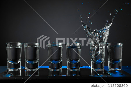 Alcoholic shots of vodka or strong drink in small glasses. 112508860