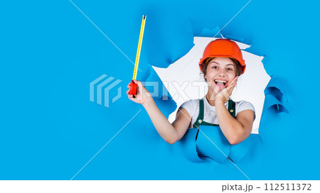kid builder wear helmet. teen girl in hard hat and uniform.  112511372