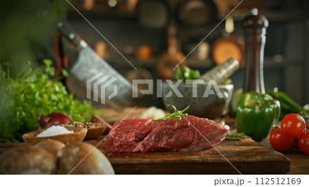 Raw Beef Steak Served on Wooden Cutting Board. Raw Beef Steak Served on Wooden Cutting Board. 112512169