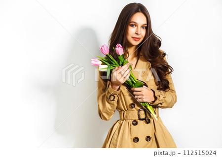 Fashion photo of beautiful woman with tulips in her hand. March 8. beautiful girl in stylish clothes 112515024