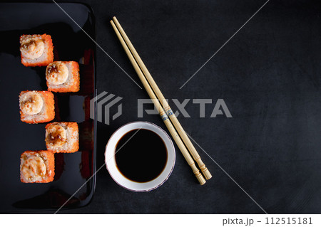 Set of sushi roll on black plate. Serving Japanese food in restaurant. Set of sushi roll on black plate. Serving Japanese food in restaurant. 112515181