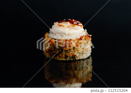 Tempura sushi roll on black background with reflection. 112515204