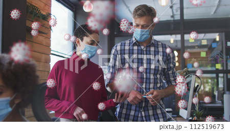 Covid-19 cells against male and female office colleagues wearing face masks discussing at office Covid-19 cells against male and female office colleagues wearing face masks discussing at office 112519673