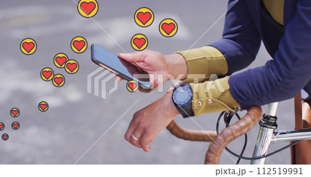 Multiple heart icons floating against mid section of woman with bicycle using smartphone Multiple heart icons floating against mid section of woman with bicycle using smartphone 112519991