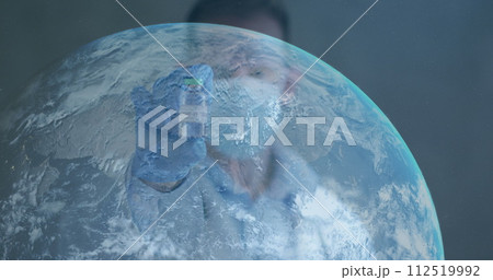 Image of globe with scientist holding covid-19 vaccine wearing face masks Image of globe with scientist holding covid-19 vaccine wearing face masks 112519992