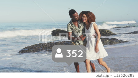 Profile icons with increasing numbers against african american couple walking on the beach 112520295