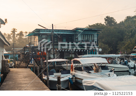 Boat at rural pier on island in the morning Boat at rural pier on island in the morning 112522153