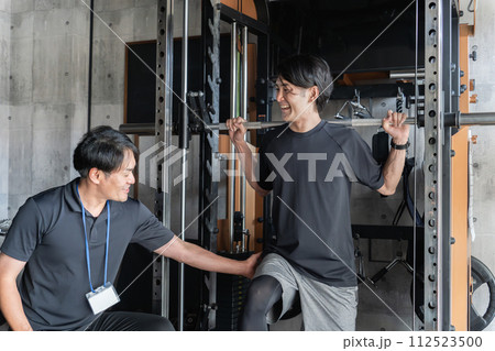 ジム・パーソナルジムのマンツーマン指導で追い込む・効かせるアジア人男性とトレーナーの男性 ジム・パーソナルジムのマンツーマン指導で追い込む・効かせるアジア人男性とトレーナーの男性 112523500