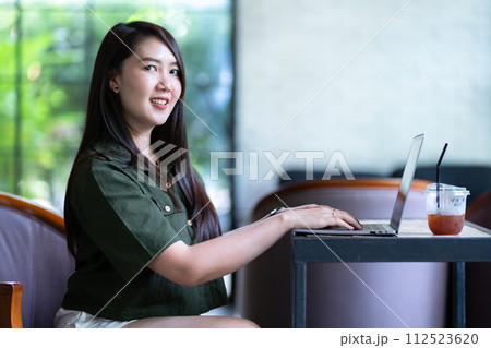 Happy of asian freelance people business female casual working with laptop computer with coffee cup and smartphone in coffee shop like the background,communication concept 112523620