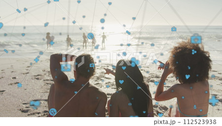 Image of network of digital icons over friends on beach Image of network of digital icons over friends on beach 112523938