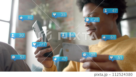 Image of data processing over african american man paying with card over smartphone 112524380