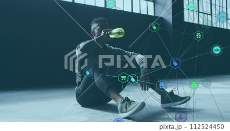 Image of network of connections with technological icons over man pouring water on head 112524450