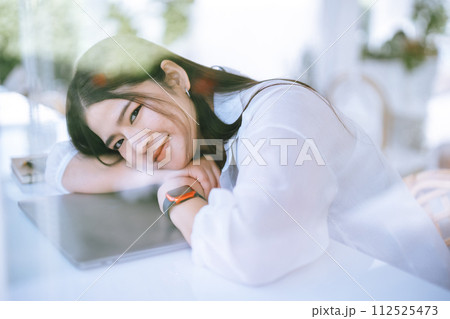modern portrait of beautiful happy asian woman traveler wearing smartwatch wearing beautiful white dress and wear jeans lifestyle enjoying in sitting coffee shop restaurant background modern portrait of beautiful happy asian woman traveler wearing smartwatch wearing beautiful white dress and wear jeans lifestyle enjoying in sitting coffee shop restaurant background 112525473