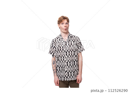 portrait of a slender young man with golden copper hair and a tattoo on his arms dressed in a black portrait of a slender young man with golden copper hair and a tattoo on his arms dressed in a black 112526290