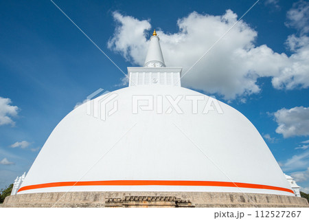 View of Ruwanwelisaya stupa in ancient city of Anuradhapura, Sri Lanka. Ruwanwelisaya stupa is one of the world's tallest ancient monuments and containing Buddha relics. View of Ruwanwelisaya stupa in ancient city of Anuradhapura, Sri Lanka. Ruwanwelisaya stupa is one of the world's tallest ancient monuments and containing Buddha relics. 112527267