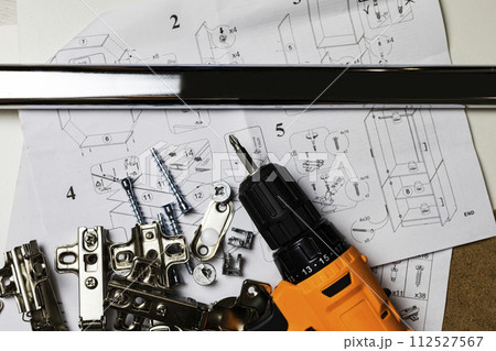 Furniture fittings. Furniture assembly hardware options and tools on a white background. 112527567