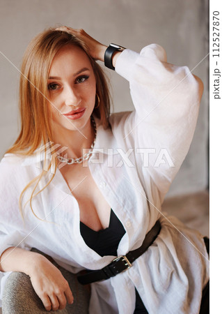 Portrait of sexy redhead young woman in white shirt.  112527870