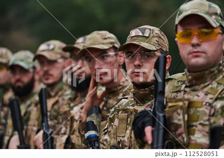 Soldier fighters standing together with guns. Group portrait of US army elite members, private military company servicemen, anti terrorist squad 112528051