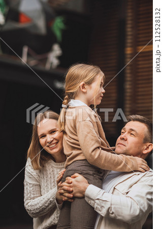 Happy family on a walk in the city. Mom, dad and teenage daughter having fun. 112528132