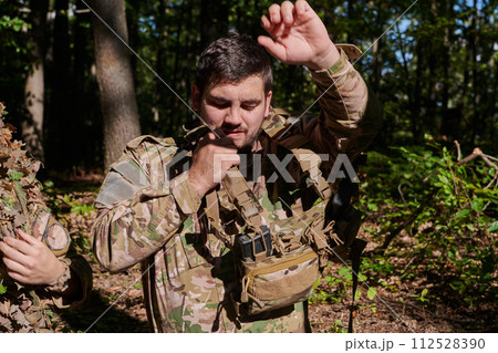 Elite soldier exudes focused determination and readiness, geared up for a perilous military operation, capturing the essence of courage and professionalism in the face of imminent danger 112528390