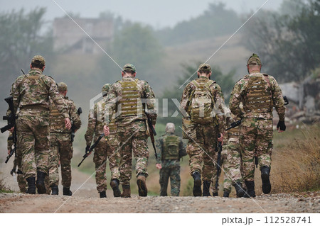 A disciplined and specialized military unit, donned in camouflage, strategically patrolling and maintaining control in a high-stakes environment, showcasing their precision, unity, and readiness for 112528741