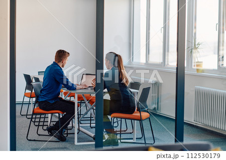 A business leader in a suit conversing with her worker in the IT industry about new business projects and existing business problems A business leader in a suit conversing with her worker in the IT industry about new business projects and existing business problems 112530179