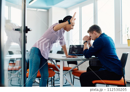 A furious business director of a startup office berating her employee for business mistakes and errors A furious business director of a startup office berating her employee for business mistakes and errors 112530205