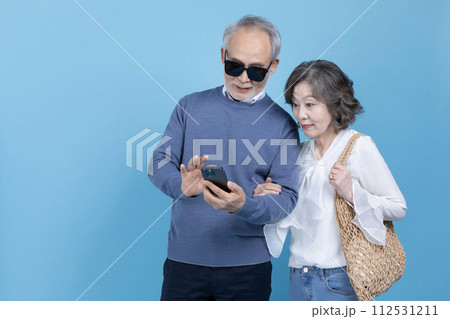 Senior photo of you holding your smartphone and searching Senior photo of you holding your smartphone and searching 112531211