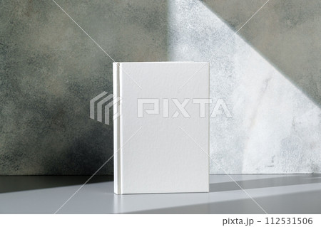 White notepad with hard cover on gray background 112531506