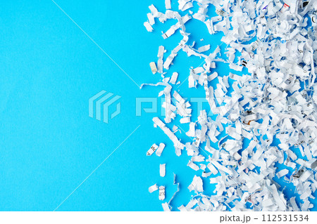 Shredded paper pieces on a blue background 112531534