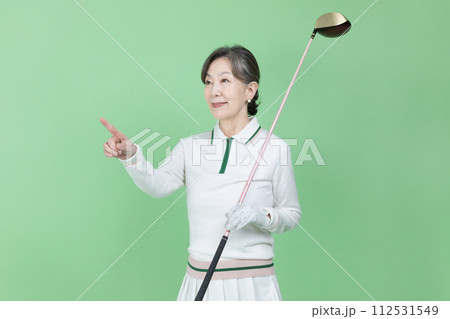 A senior woman holding a golf club A senior woman holding a golf club 112531549